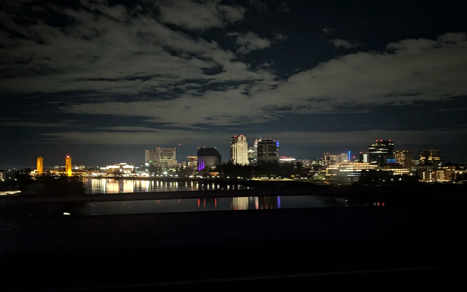 Sacramento downtown skyline at night as viewed from US Route 50, showing city lights and urban development